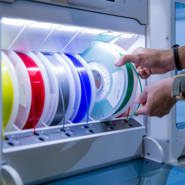 Close-up of six colored filament spools loaded in the UltiMaker Material Station